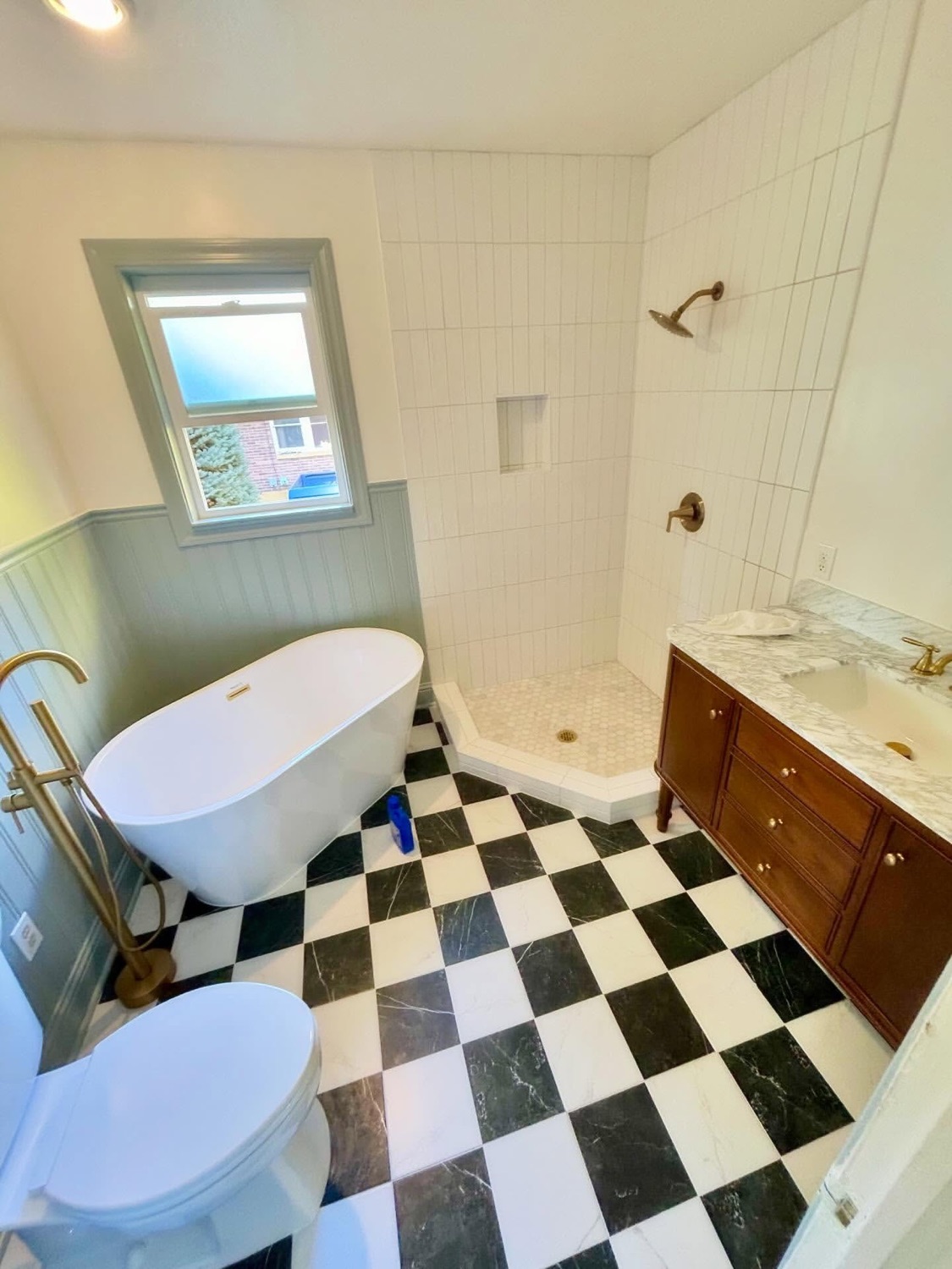 Finished bathroom remodel with freestanding tub and tiled shower