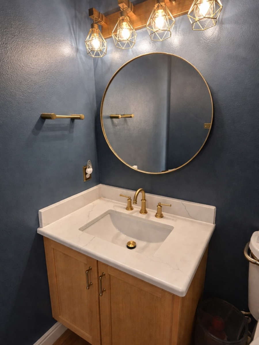 Remodeled powder room with gold fixtures